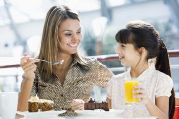 Royalty Free Photo of a Mother and Daughter Eating Cake