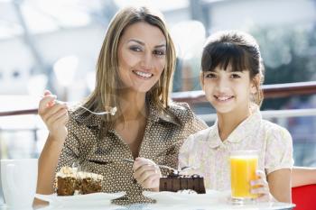 Royalty Free Photo of a Mother and Daughter Eating at a Restaurant