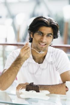 Royalty Free Photo of a Man Eating Dessert