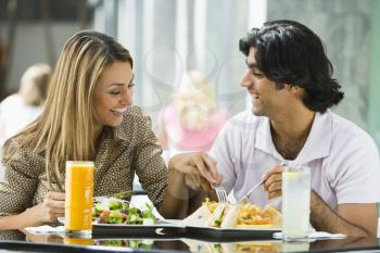Royalty Free Photo of a Couple Eating at a Restaurant