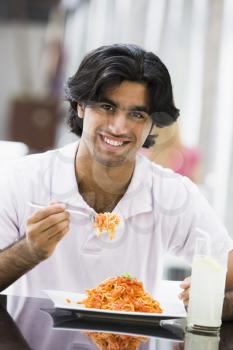 Royalty Free Photo of a Man Eating Spaghetti