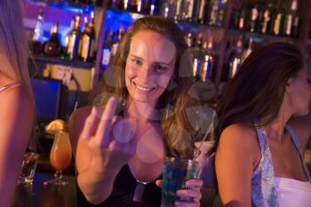 Royalty Free Photo of a Woman in a Bar With Friends