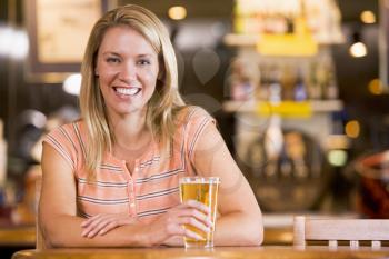 Royalty Free Photo of a Woman Having a Glass of Beer