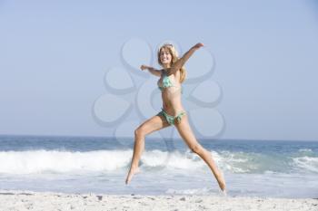 Royalty Free Photo of a Happy Girl Jumping on the Beach