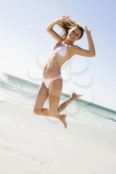 Royalty Free Photo of a Girl Jumping at the Beach