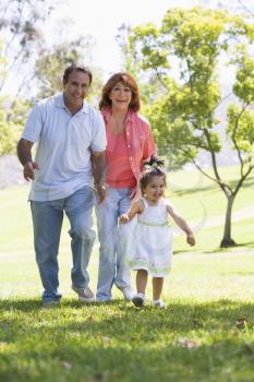 Royalty Free Photo of a Couple With a Little Girl in a Park