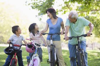 Royalty Free Photo of a Couple Biking With Their Grandchildren