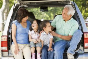 Royalty Free Photo of a Couple With Grandchildren in a Car