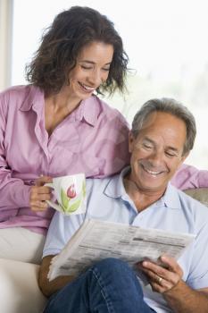 Royalty Free Photo of a Couple Relaxing With the Newspaper