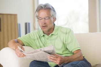 Royalty Free Photo of a Man Relaxing With a Newspaper