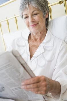 Royalty Free Photo of a Woman Reading a Newspaper