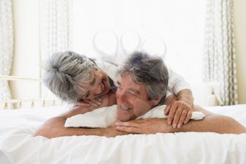 Royalty Free Photo of a Couple Cuddling in Bed