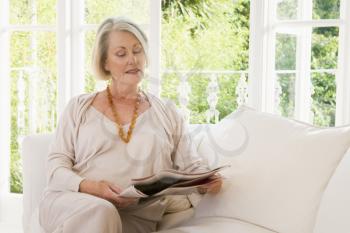 Royalty Free Photo of a Woman Reading a Magazine