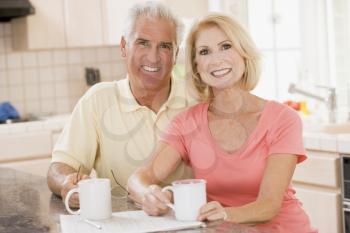 Royalty Free Photo of a Couple With the Paper and Coffees