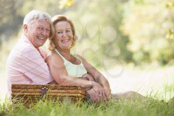 Royalty Free Photo of a Couple Outside With a Picnic Basket