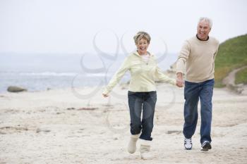 Royalty Free Photo of a Couple Running at the Beach