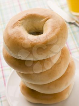 Royalty Free Photo of a Stack of Plain Bagels and Orange Juice