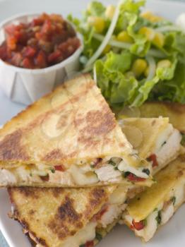 Royalty Free Photo of Quesadillas with Cajun Chicken Cheese Tomato Salsa and corn Salad