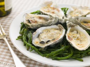 Royalty Free Photo of Grilled Oysters with Mornay Sauce on Samphire
