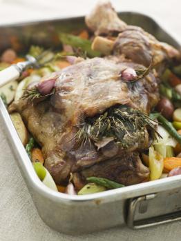 Royalty Free Photo of a Slow Roasted Shoulder of Lamb Stuffed with Herbs de Provence Roasted Vegetables