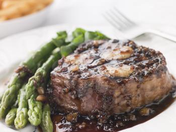 Royalty Free Photo of a Fillet of Beef Bordelaise with Asparagus Spears and Saut Potatoes