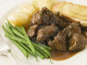 Royalty Free Photo of a Beef Carbonnade With a Mustard Crouton and Green Beans