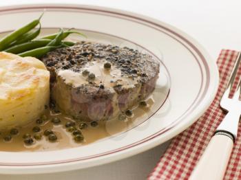 Royalty Free Photo of Filet Mignon au Poirve' with French Beans and Pomme Anna