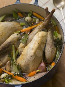 Royalty Free Photo of ot Roasted Guinea Fowl with Spring Vegetables
