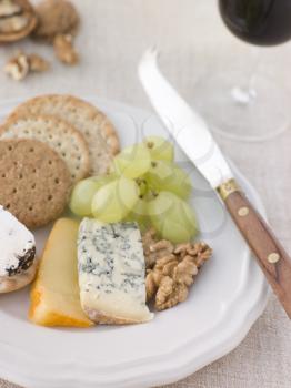 Royalty Free Photo of a Plate of Cheese and Biscuits with a Glass of Port