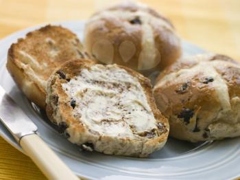 Royalty Free Photo of a Plate of Toasted Hot Cross Buns With Butter
