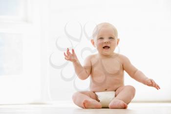 Royalty Free Photo of a Baby Sitting on the Floor