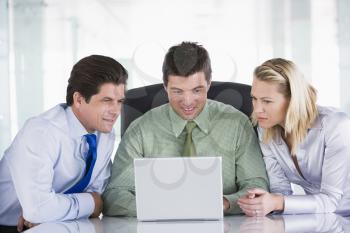 Royalty Free Photo of Three People Looking at a Laptop