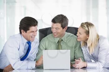 Royalty Free Photo of Three People at a Laptop