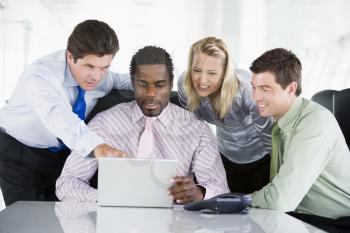 Royalty Free Photo of a Group of People Around a Laptop