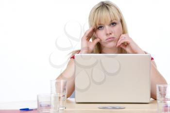 Royalty Free Photo of a Woman at a Laptop Looking Bored
