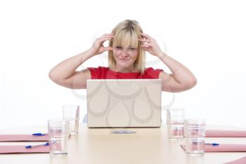 Royalty Free Photo of a Woman at a Boardroom Table Looking Angry