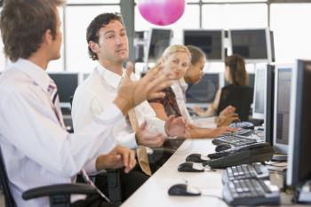Royalty Free Photo of People at Computers Bouncing a Ball