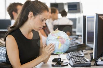 Royalty Free Photo of a People at Computers With a Globe on the Desk