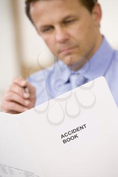 Royalty Free Photo of a Man Looking at an Accident Report