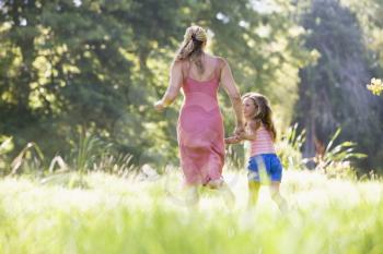 Royalty Free Photo of a Mother and Daughter Running in a Field
