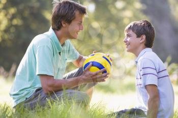 Royalty Free Photo of a Father and Son With a Ball