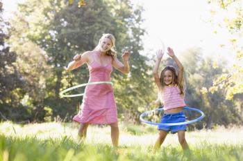 Royalty Free Photo of a Mother and Daughter With Hula Hoops