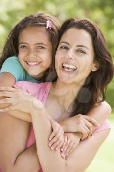 Royalty Free Photo of a Mother and Daughter Hugging Outside