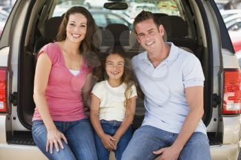 Royalty Free Photo of a Mother and Father With a Girl in a Hatchback