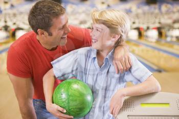 Royalty Free Photo of a Man and Boy at the Bowling Alley