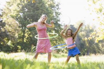 Royalty Free Photo of a Woman and Girl With a Hula Hoop