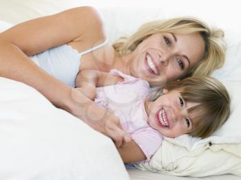 Royalty Free Photo of a Mother and Daughter Cuddling in Bed