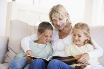 Royalty Free Photo of a Woman Reading to Two Children