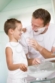 Royalty Free Photo of a Man Shaving With His Son