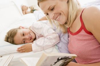 Royalty Free Photo of a Woman Reading a Bedtime Story to Her Daughter